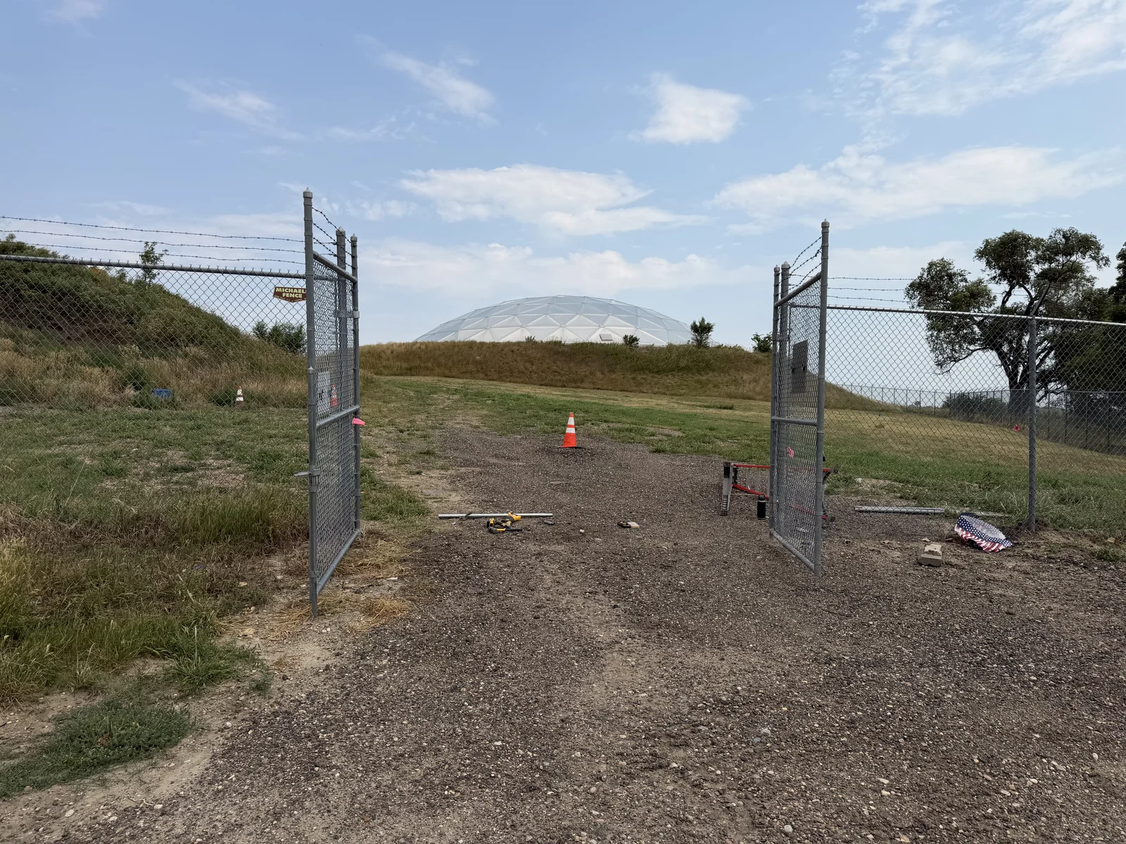 Commercial chain-link fence and double gates with barbed wire above, repaired by Henley Fencing