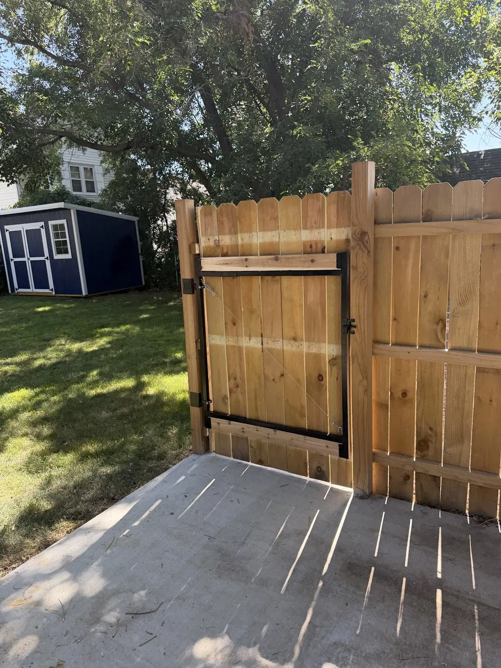 New wood gate with black hardware